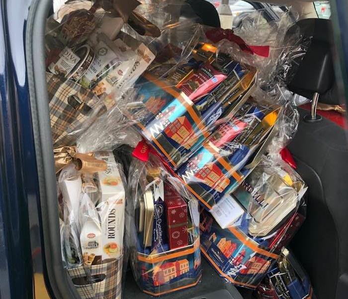 car filled with baskets of chocolate and Christmas goods