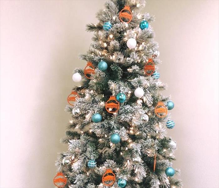 Frosted Christmas Tree with Blue, White, and Orange SERVPRO Ornaments